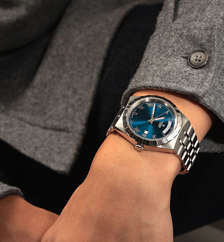 Tudor Royal collection stainless steel link strap watch with teal dial on wrist