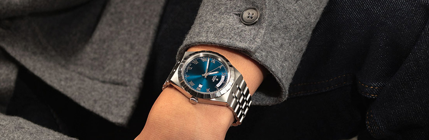 Tudor Royal collection stainless steel link strap watch with teal dial on wrist