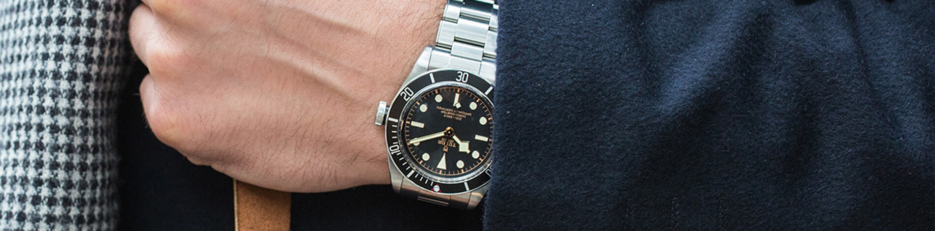 Tudor stainless steel link strap watch with black and gold dial