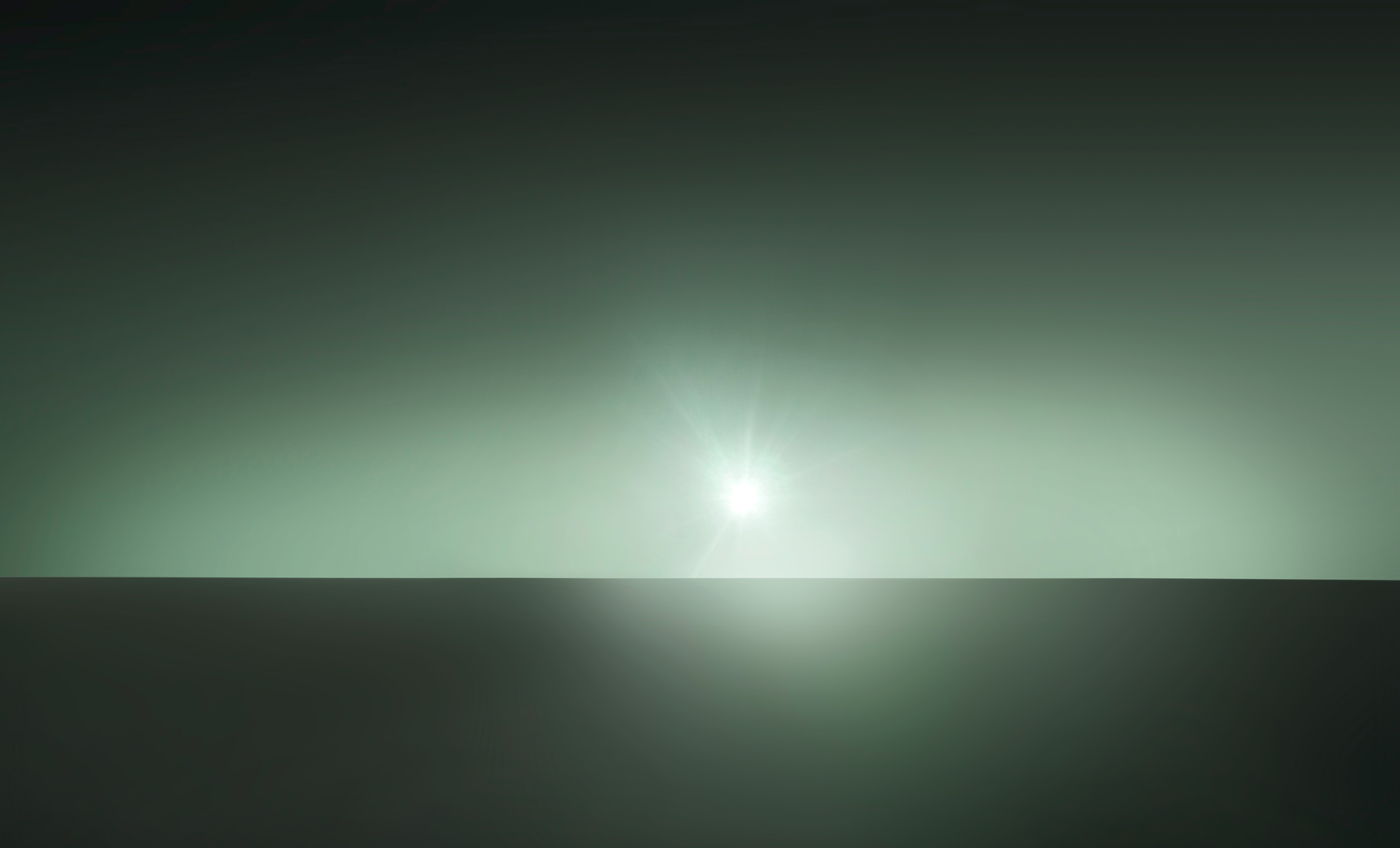 Abstract green sun over horizon