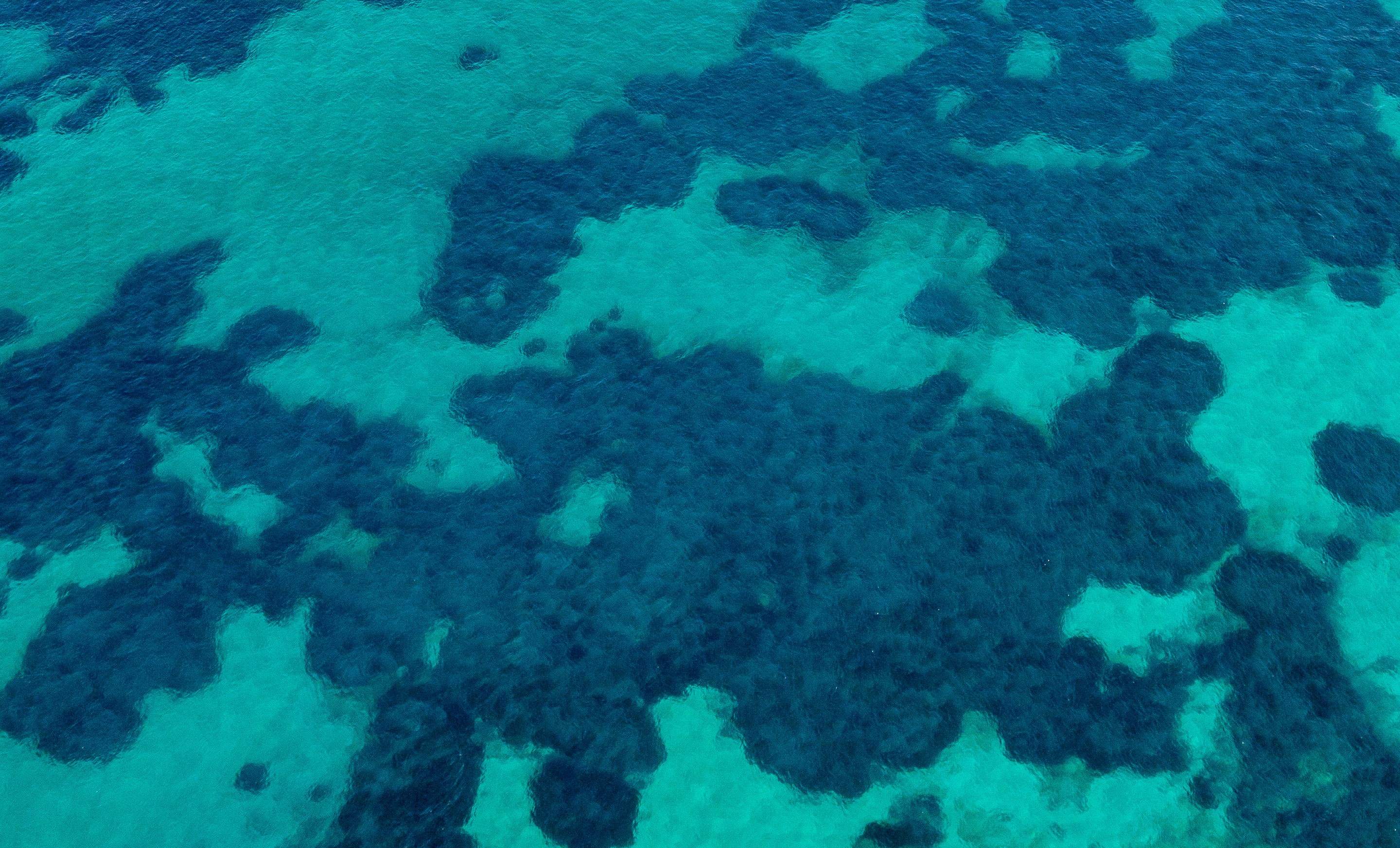 Two-tone blue sea as seen from above