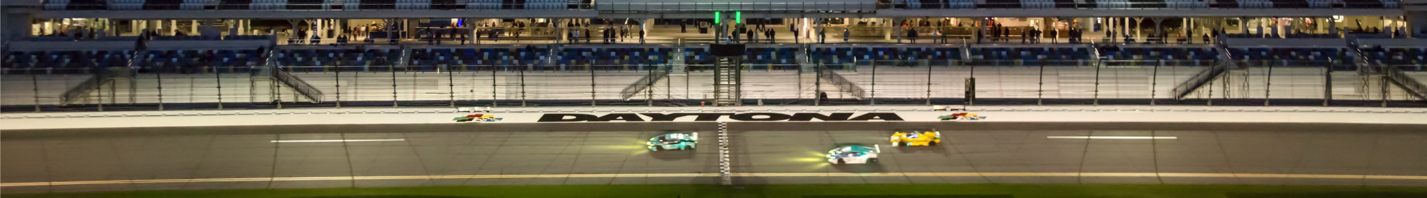 Motorsports cars racing along track
