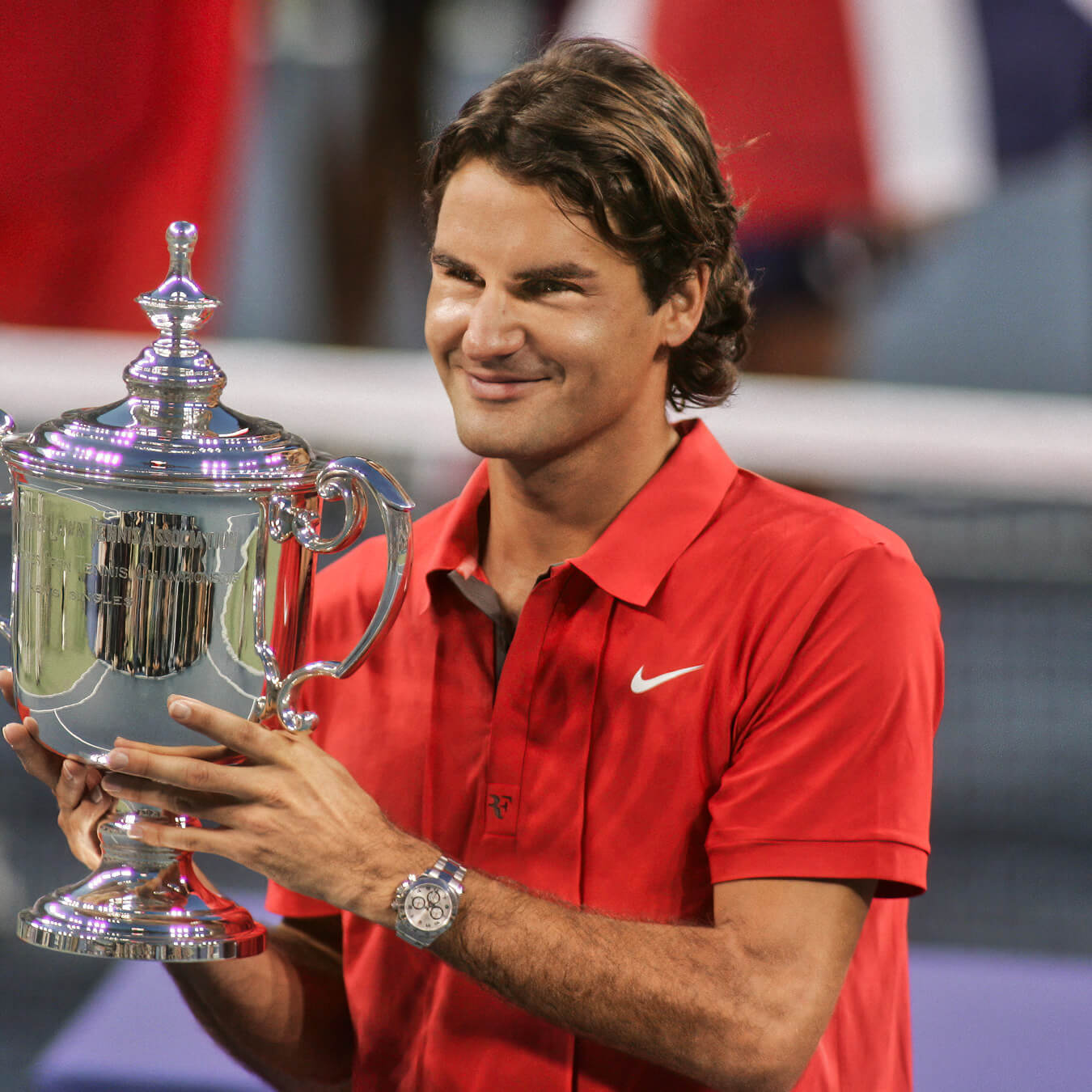 Roger Federer holding Rolex US Open trophy wearing silver Rolex watch