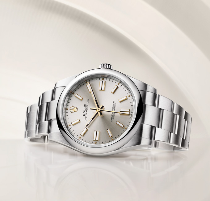 Silver Rolex Oyster Perpetual with link strap and gold watch hands