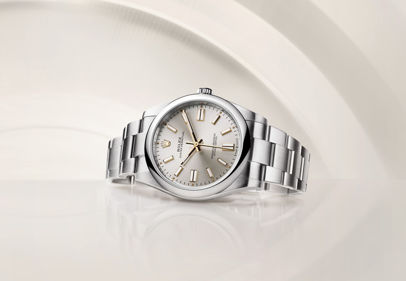 Silver Rolex Oyster Perpetual with link strap and gold watch hands