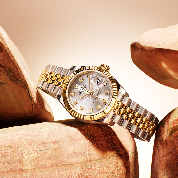 Ladies two-tone Rolex Datejust watch with link bracelet and diamond detail around dial