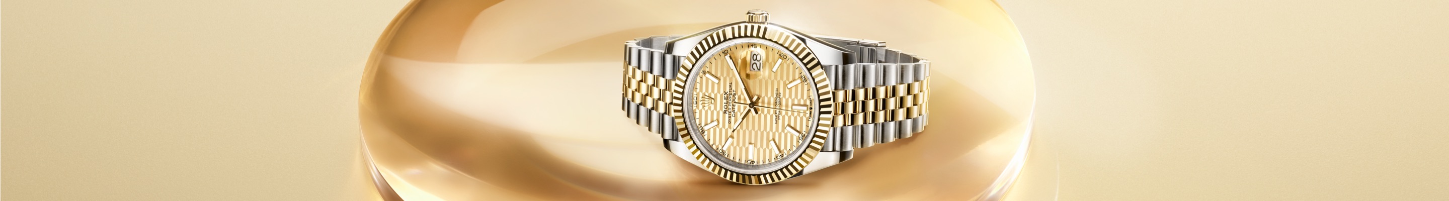 Two-tone Rolex Datejust on gold setting banner