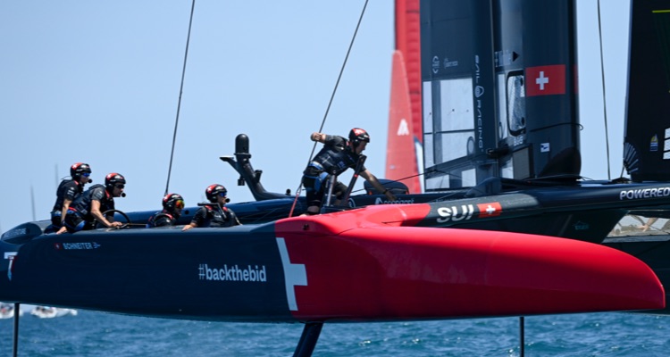 Men on sail boat featuring Swiss flag