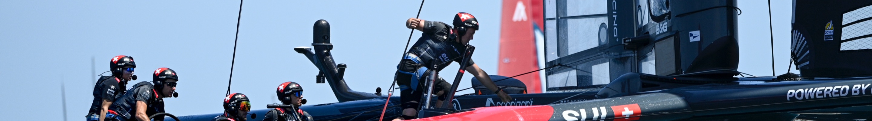 Men on sail boat featuring Swiss flag, Sail GP