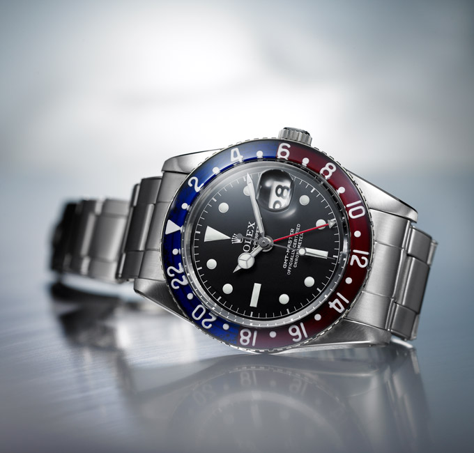 Rolex Oyster Perpetual silver watch with red and blue detail