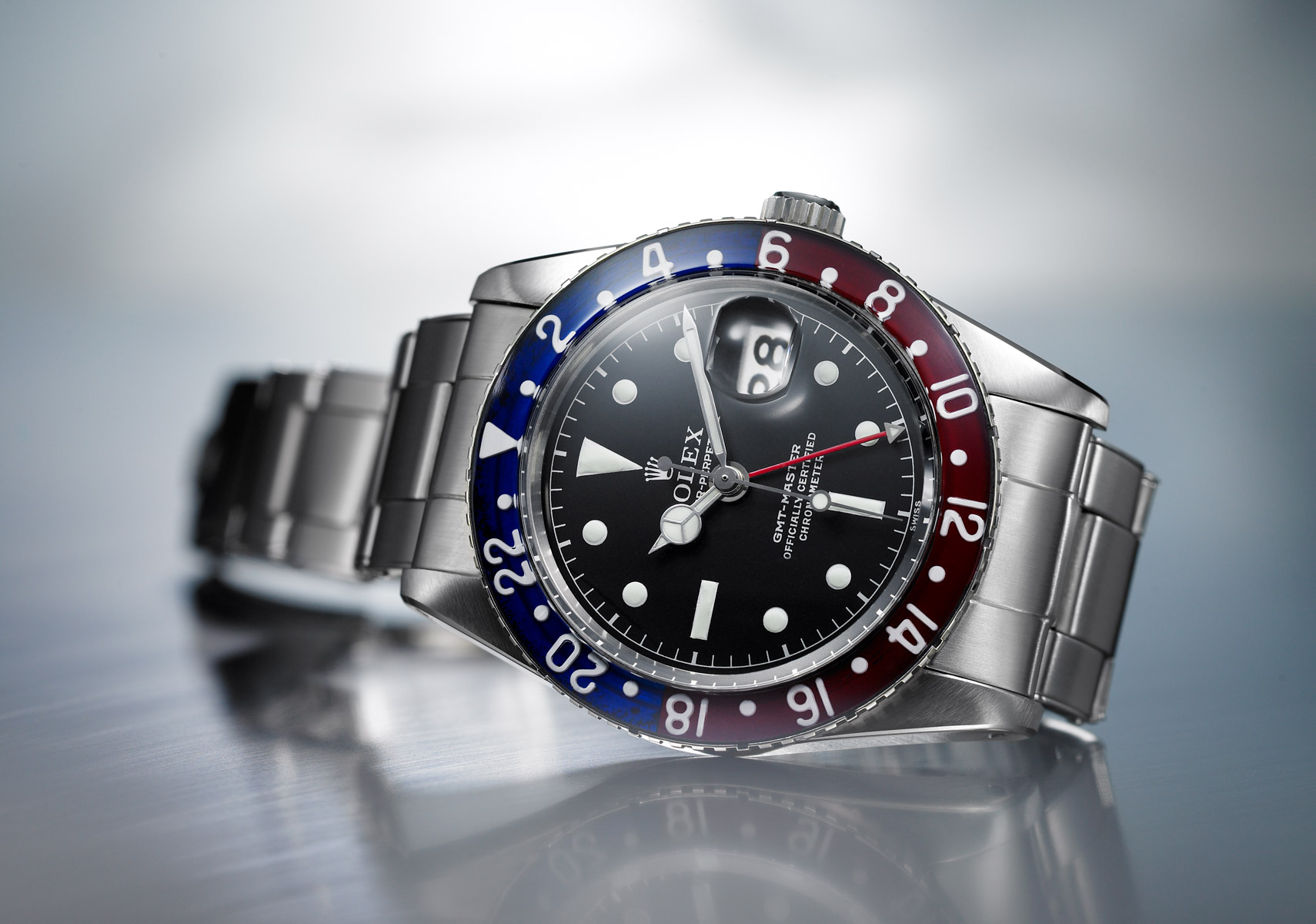 Rolex Oyster Perpetual silver watch with red and blue detail
