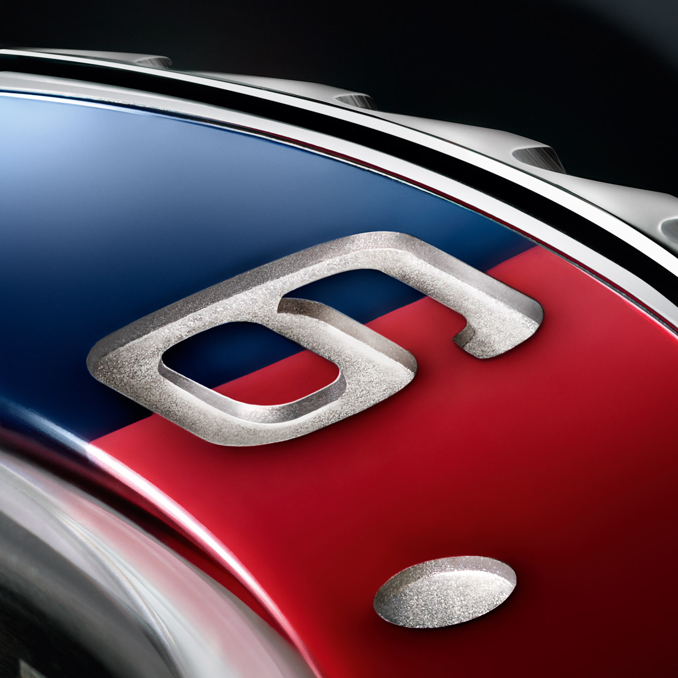 Number 6 on red and blue split background, watch dial detailing