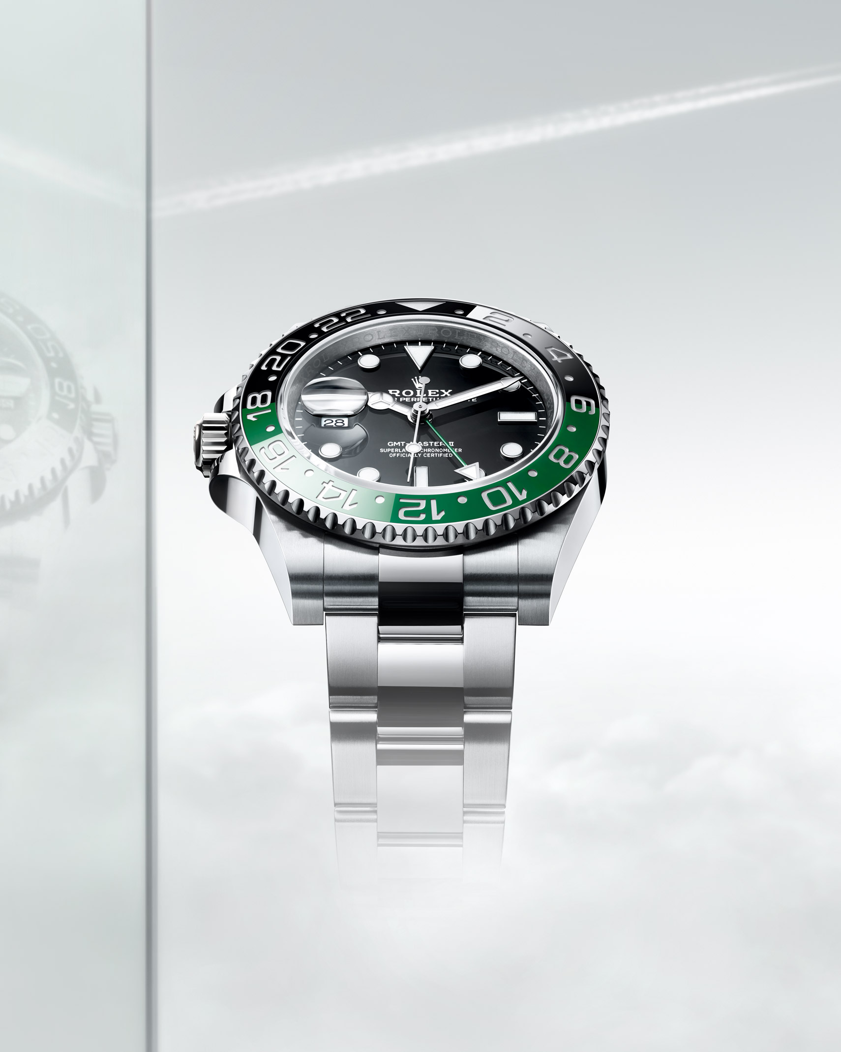 Rolex Oyster Perpetual silver watch with green and black dial detail