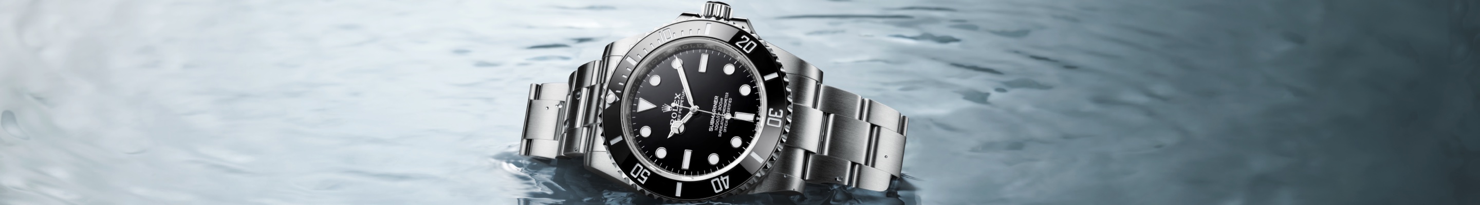 Silver Rolex Oyster Perpetual with black dial in water
