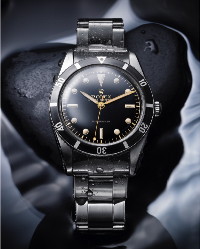 Silver Rolex Oyster Perpetual with black dial and gold detailing