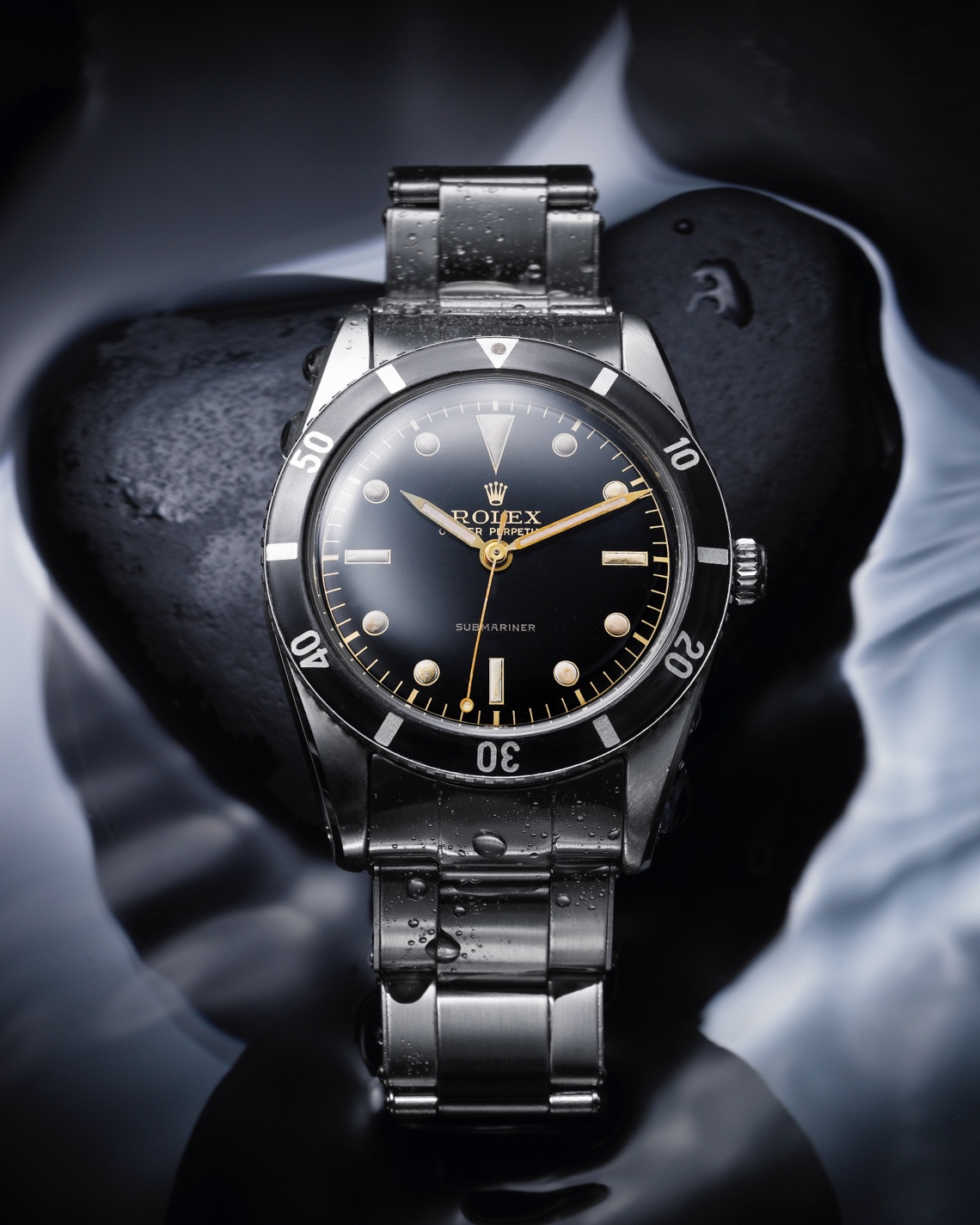 Silver Rolex Oyster Perpetual with black dial and gold detailing