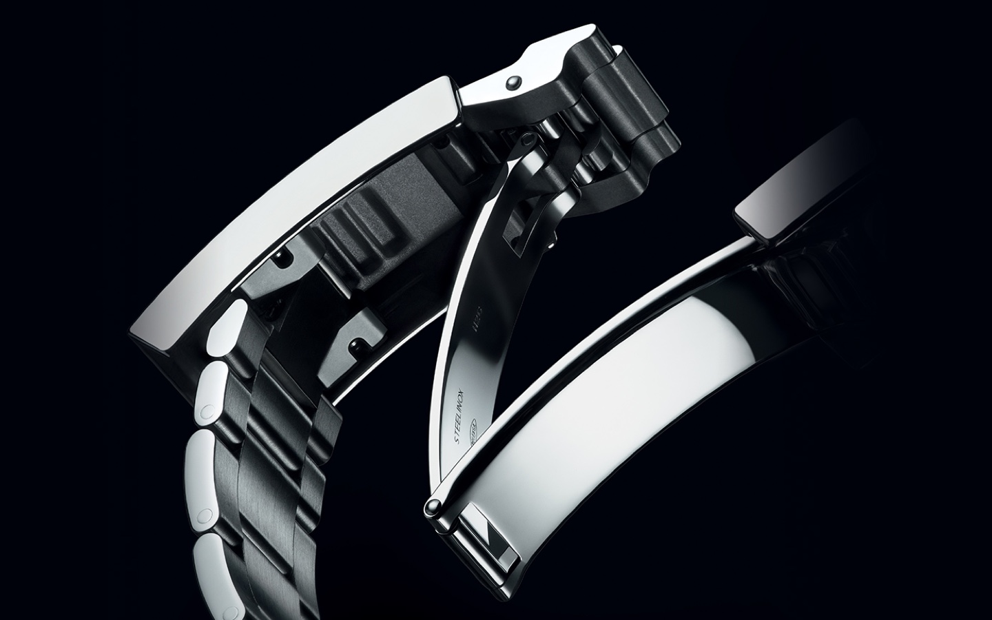 Silver Rolex watch fastening on black background
