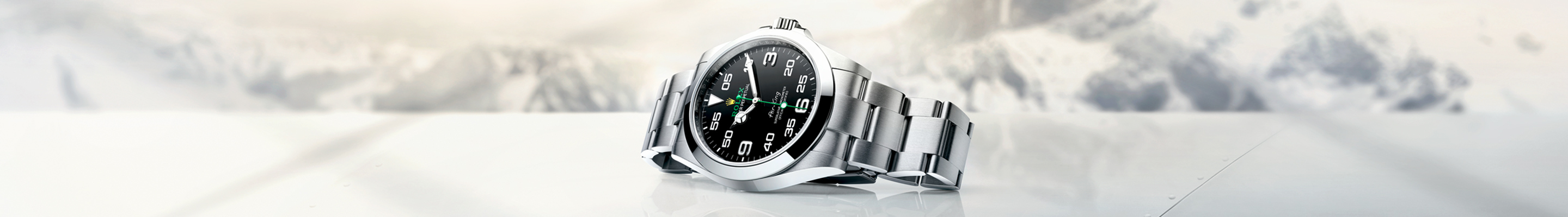 Silver Rolex Oyster Perpetual with black dial banner