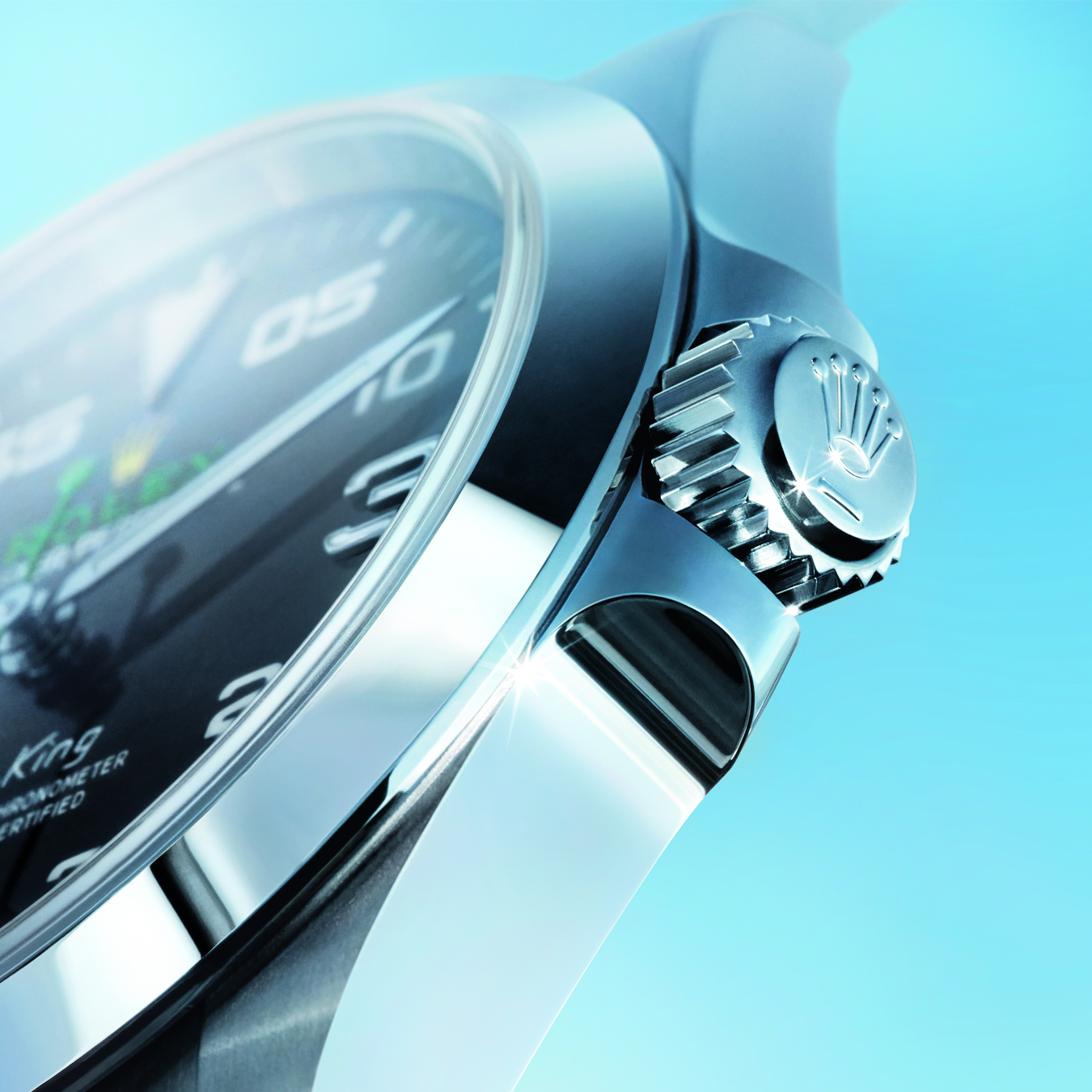 Silver Rolex crown dial on blue background