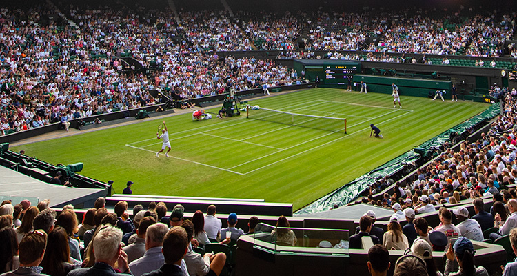 Tennis player serving at Wimbledon tournament