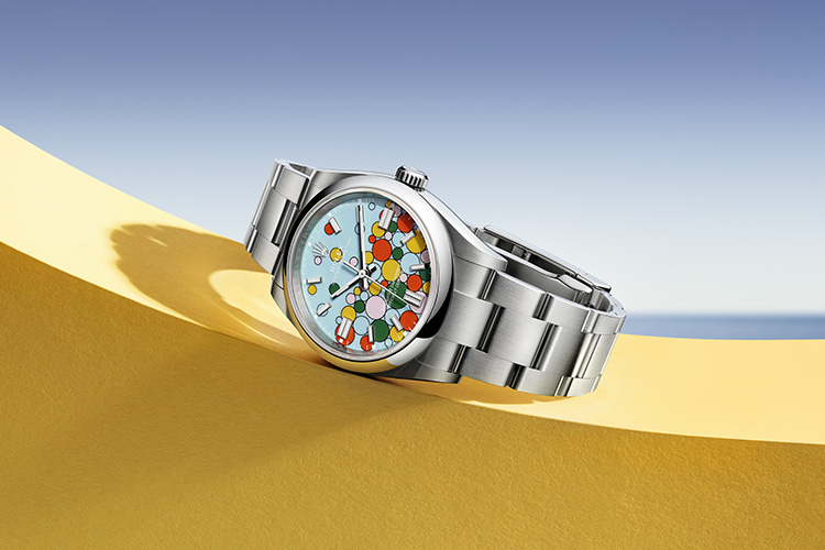 Silver Rolex Oyster Perpetual watch with vibrant colourful dial