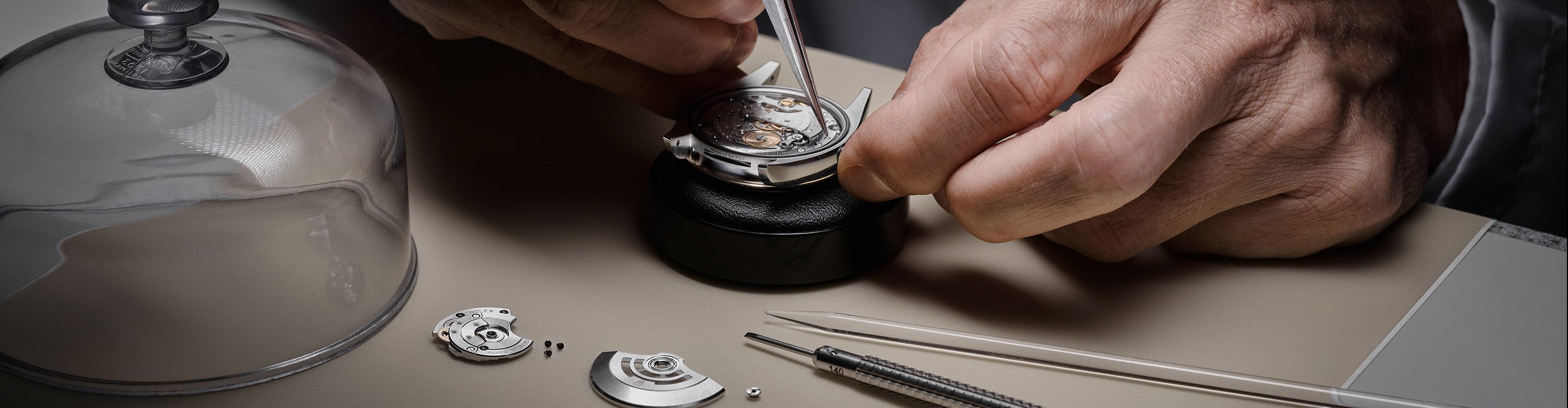 Rolex expert working on watch, deconstructed parts