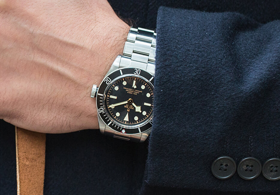 Tudor stainless steel link strap watch with black and gold dial